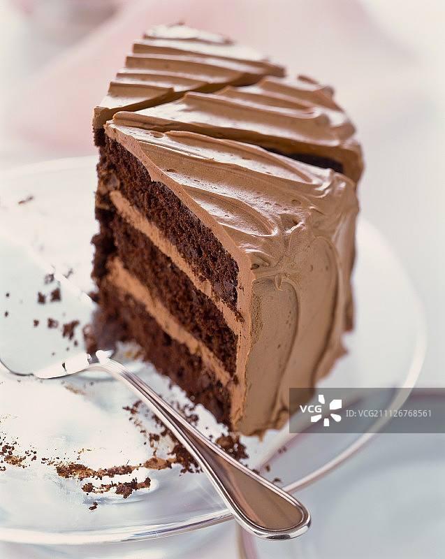 三片巧克力奶油蛋糕放在蛋糕盘上图片素材