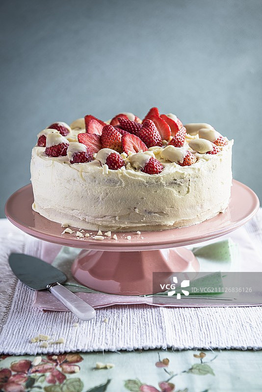 蛋糕架上放着一个白巧克力草莓蛋糕图片素材