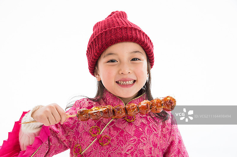 欢乐的小女孩吃糖葫芦图片素材