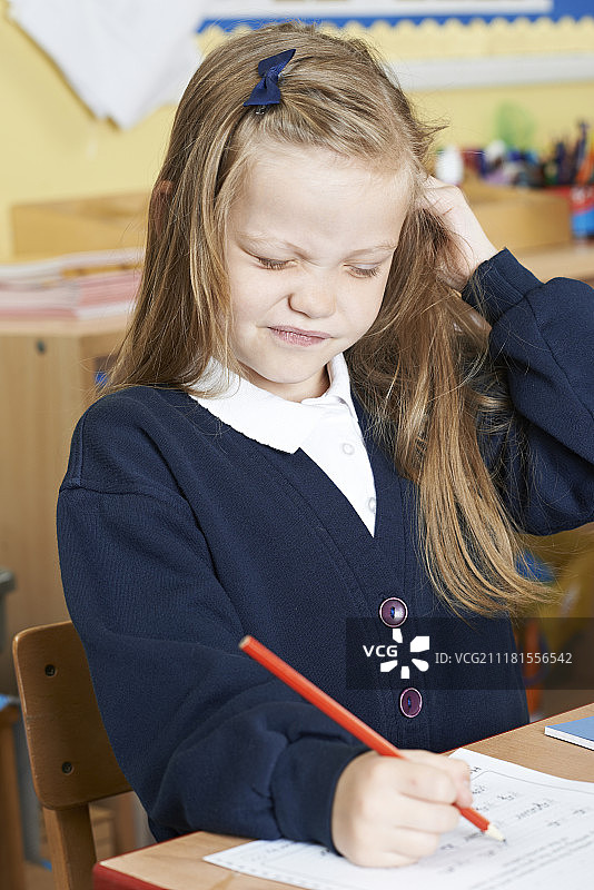 一名女小学生在教室里染上头虱图片素材