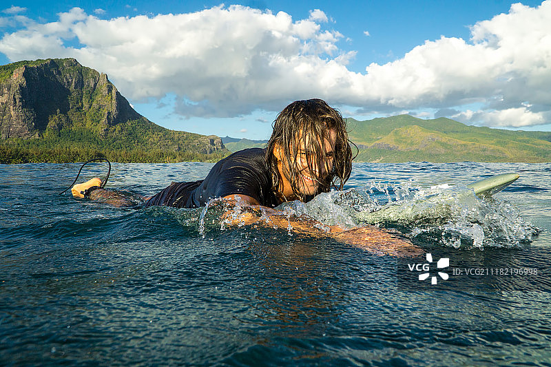 肌肉发达的冲浪者与长黑发桨海浪在印度洋岛国毛里求斯图片素材