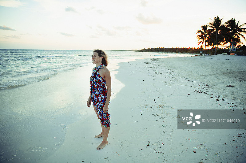 无忧无虑的女人在阳光连衣裙在宁静的海洋海滩墨西哥图片素材