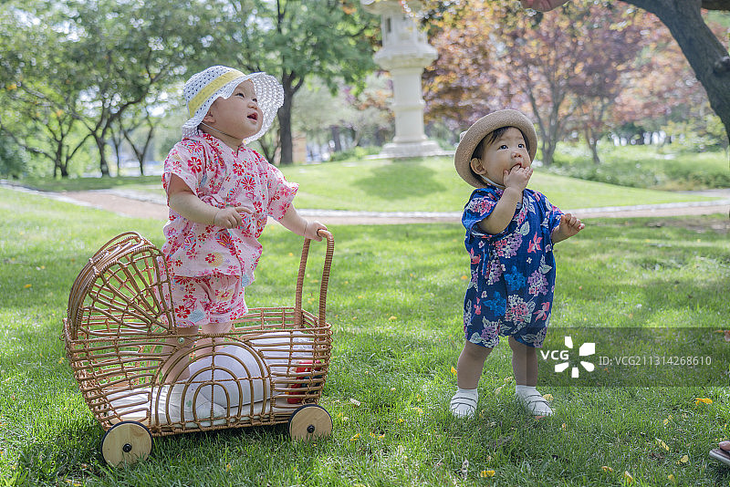 树林草坪休闲的两个穿日系夏季服婴儿图片素材
