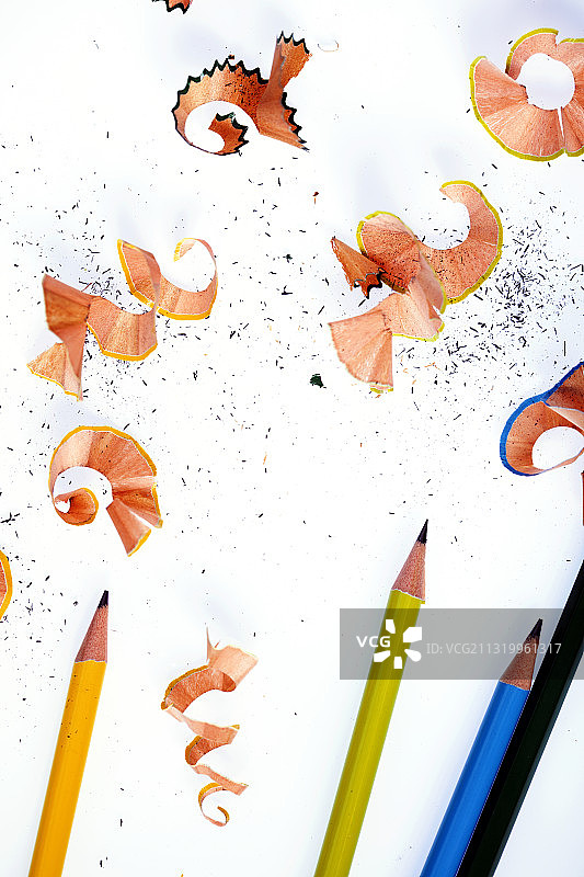 彩虹铅笔和铅笔刨花在纯白色的背景图片素材