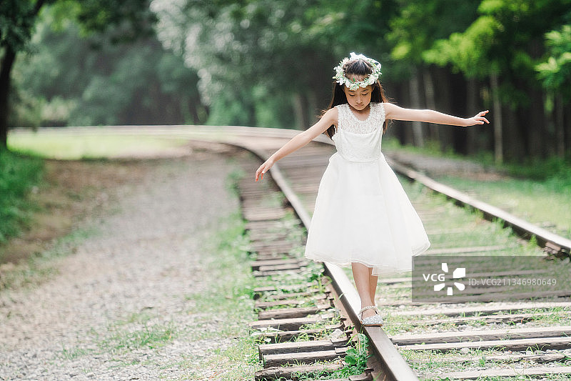 小女孩在铁轨上走图片素材