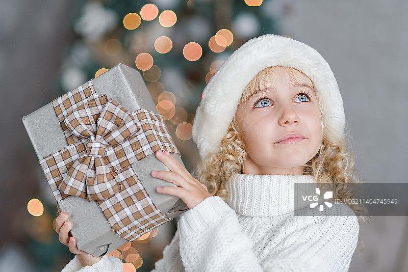 开心兴奋的小女孩抱着圣诞礼盒图片素材