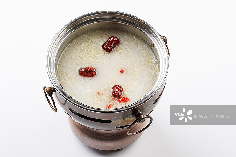 白色背景上的小火锅装的大骨奶汤锅底图片素材