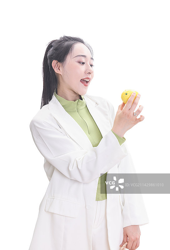 穿白色西装拿着柠檬的年轻亚洲女性图片素材