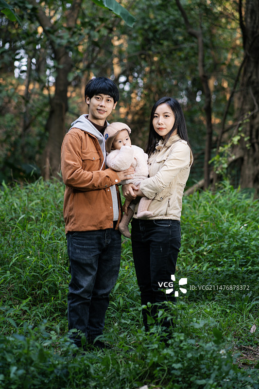 11个月的小宝宝和他的父母在山林里的合照图片素材