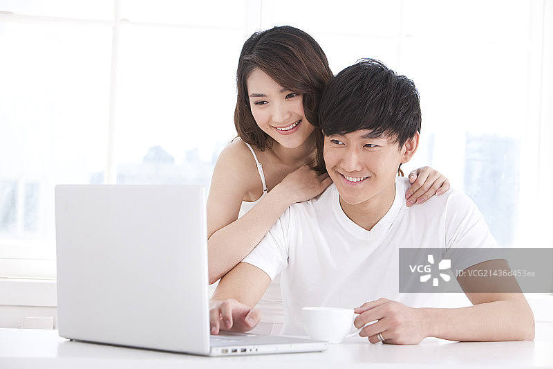 青年夫妇用笔记本电脑图片素材