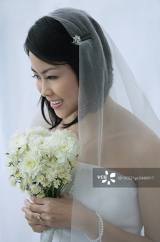 新娘捧着一束鲜花微笑着图片素材