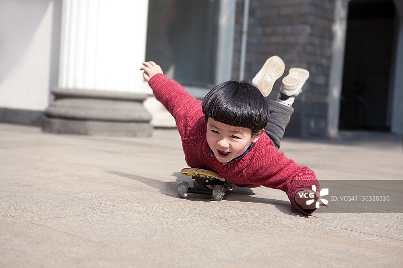 小男孩玩滑板图片素材