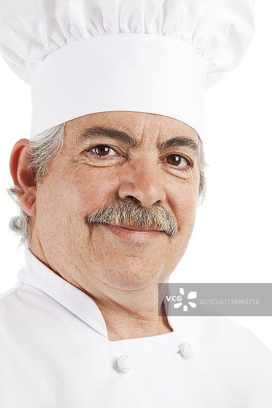 一个意大利厨师的肖像在厨师的帽子和制服图片素材