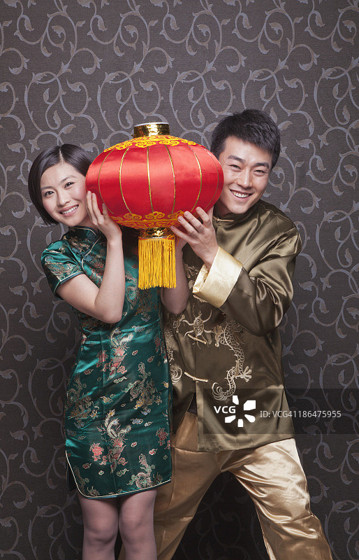 年轻夫妇手拿中国传统服饰灯笼图片素材