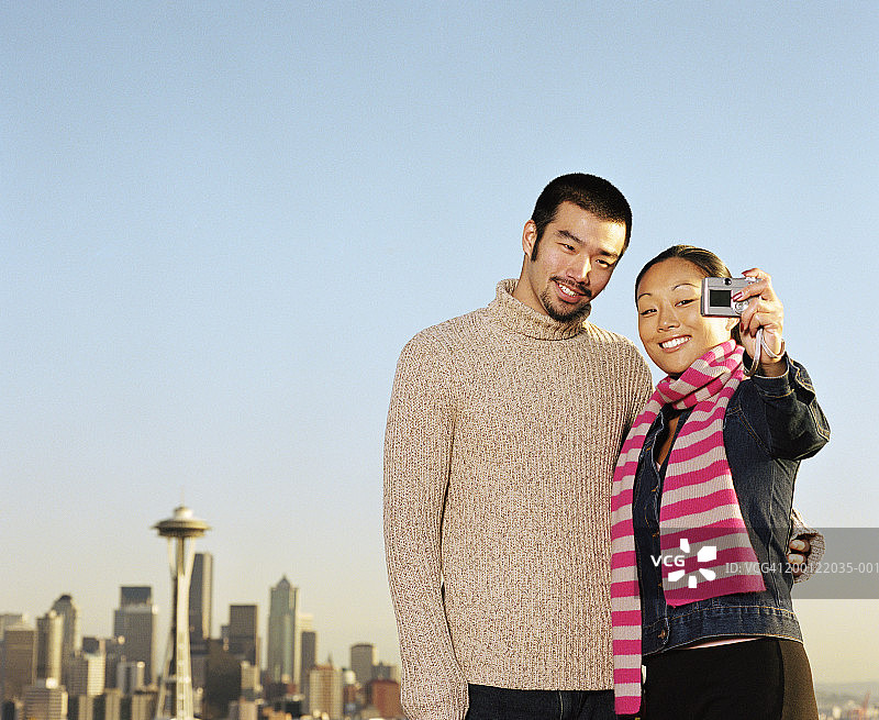 美国西雅图，一对年轻夫妇用数码相机自拍图片素材