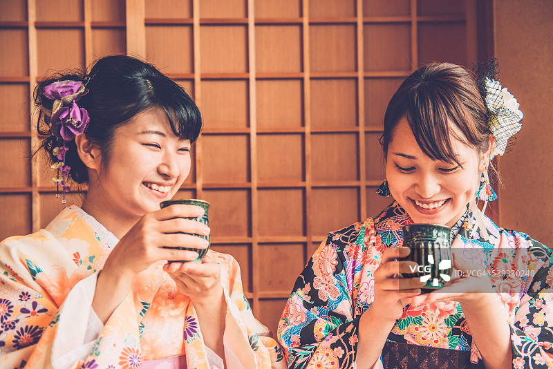 穿着和服的美丽日本女人喝抹茶，京都，日本图片素材