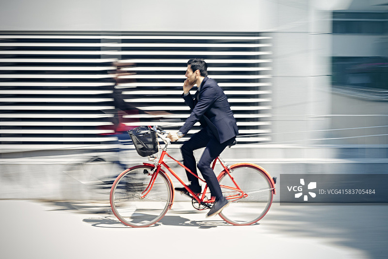 在城市里骑自行车的商人图片素材