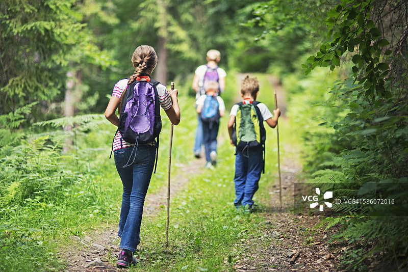 妈妈和孩子们在森林里徒步旅行图片素材