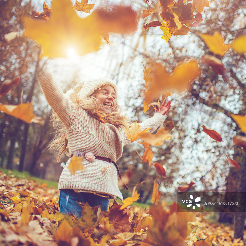 小女孩在秋天的公园里图片素材