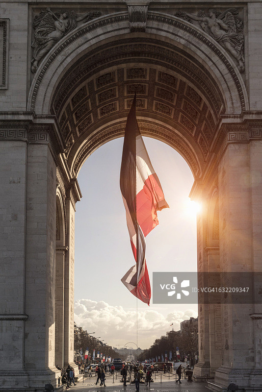 阳光下的法国国旗和凯旋门，巴黎，法国图片素材