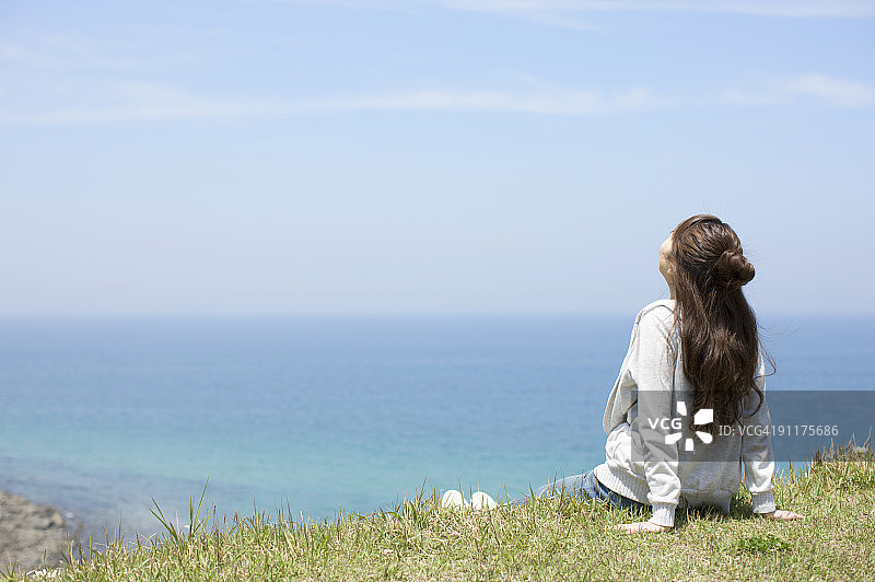 坐在海边的年轻女子图片素材