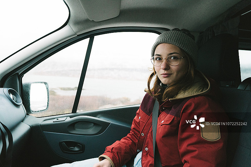 一个女人坐在野营车的副驾驶座上图片素材