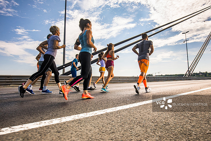 下图是一群运动员在公路上跑马拉松比赛。图片素材