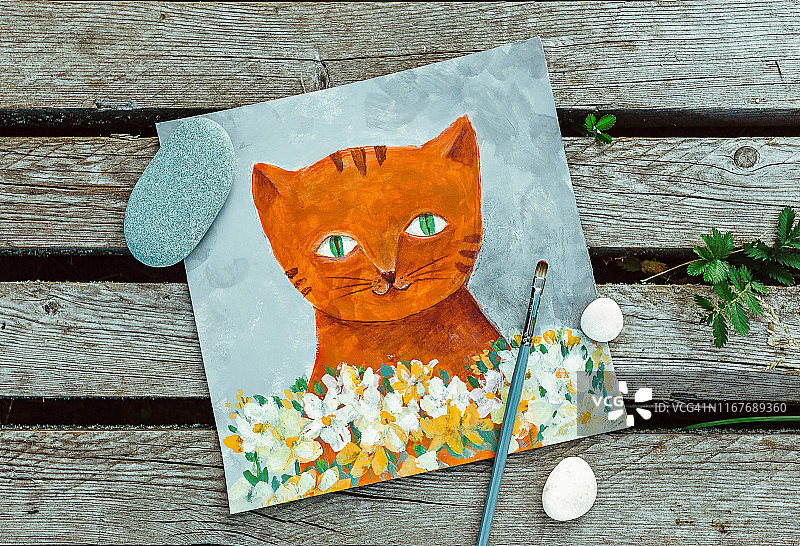 姜猫与白花插图在一个木制的背景。用石头和木头构成的平面构图。美术丙烯纸画图片素材