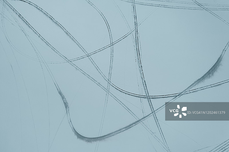 鸟瞰图的轮胎足迹在冰雪覆盖的沙漠图片素材