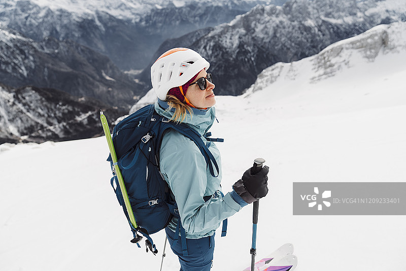 在白雪覆盖的阿尔卑斯山滑雪旅游的女人图片素材