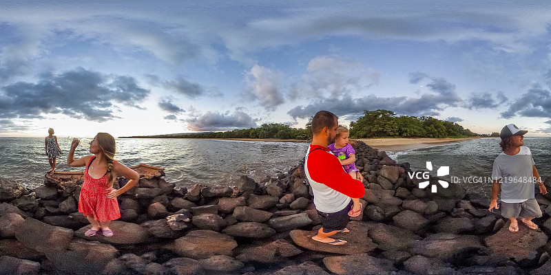 一个家庭在欣赏考艾岛海岸日落时的360张照片。图片素材