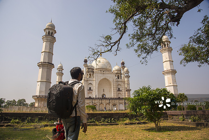 印度马哈拉施特拉邦奥兰加巴德Bibi ka Maqbara前，一名背着背包的游客图片素材
