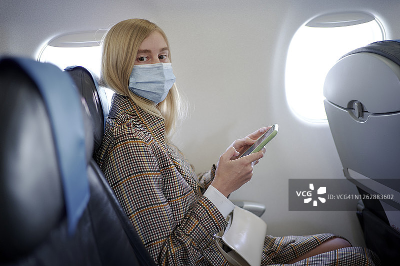 在飞机上戴着面具的女人图片素材