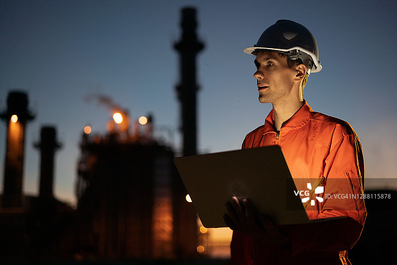 工程师使用数字平板在石油炼油厂上夜班图片素材