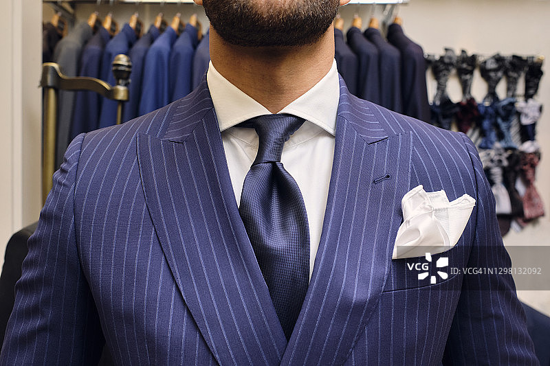 穿着蓝色细条纹西装的男人在裁缝店图片素材