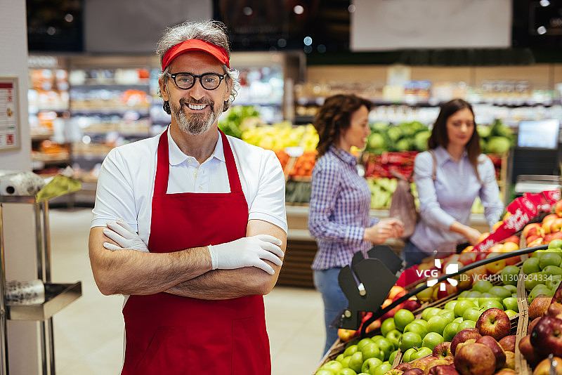 自信微笑的超市职员在超市摆姿势图片素材