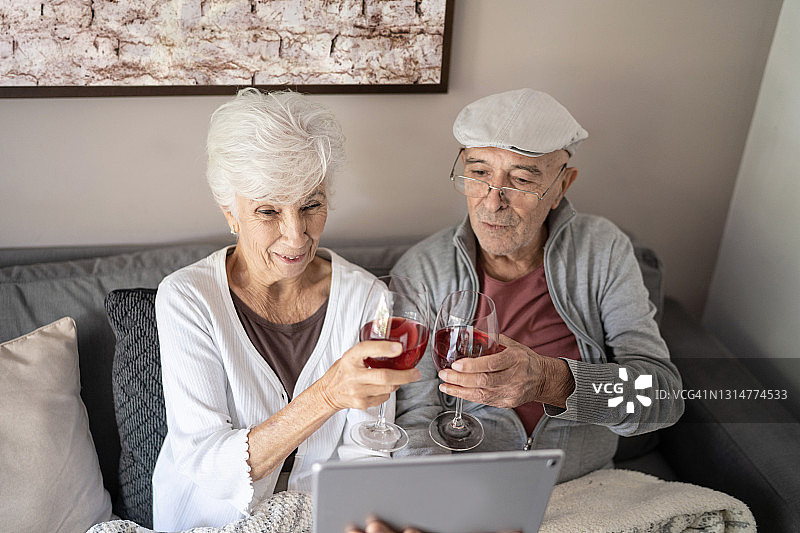 一对老年夫妇在家用平板电脑玩虚拟欢乐时光图片素材