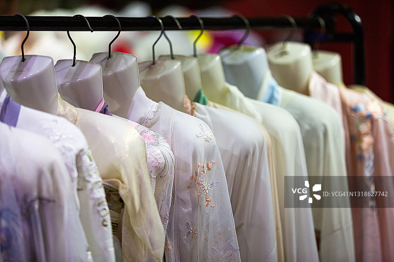 苏州丽丽古镇的商店里挂着中式丝绸衣服。中国江苏省苏州市图片素材