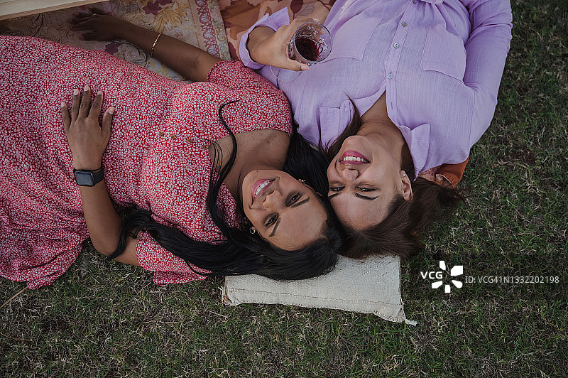 两个年轻女人一起在草地上放松图片素材