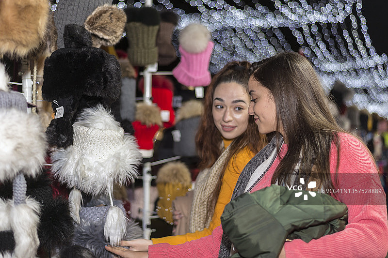 两个女性朋友走在露天的圣诞集市上图片素材