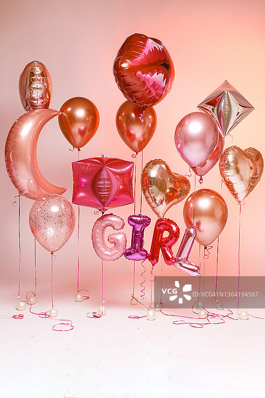 时尚的金属粉红色气球情人节，母鸡派对，婴儿淋浴或性别派对在一个梯度粉红色的背景。碑文“女孩”。图片素材