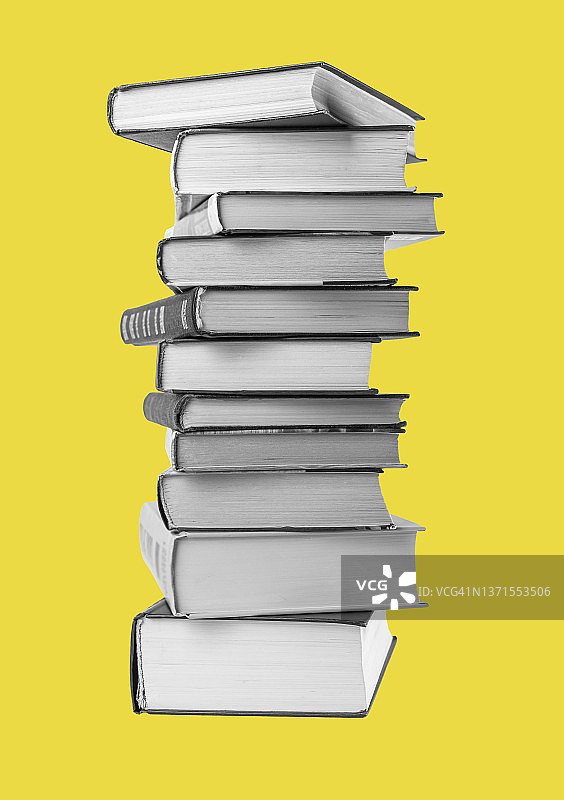 大书堆在黄色的背景上。教育、阅读文学观念图片素材
