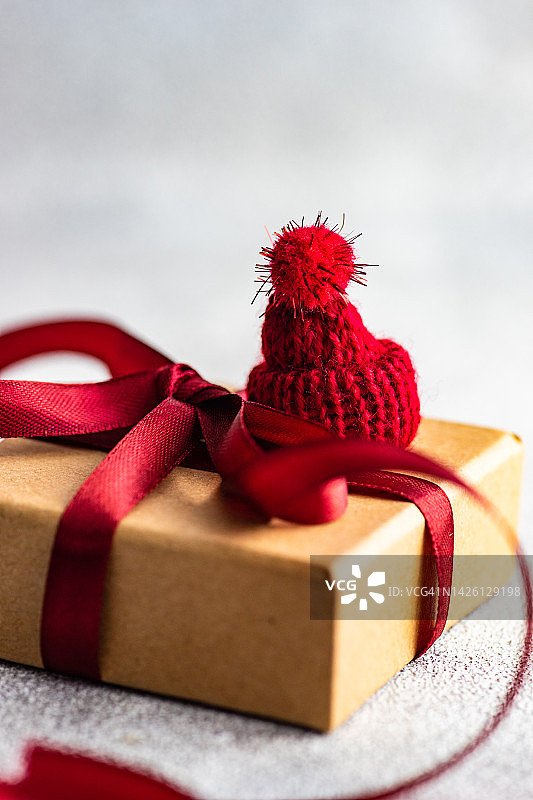 特写的圣诞礼盒与丝带系和装饰与微型圣诞老人帽子图片素材