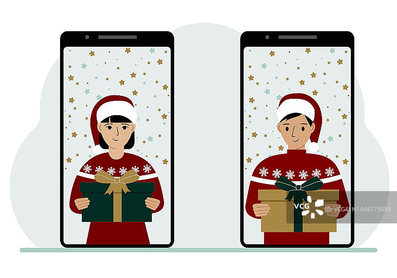 一名女子和一名男子通过手机视频会议在网上见面，虚拟讨论圣诞和新年假期和礼物。图片素材