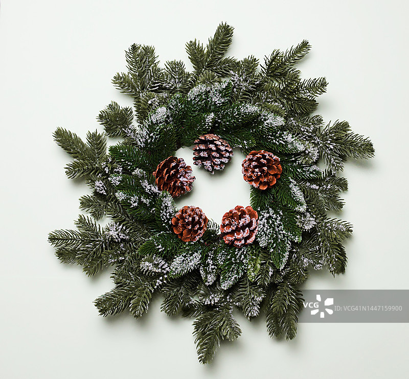 淡绿色背景上的圆锥形圣诞花环。照片图片素材