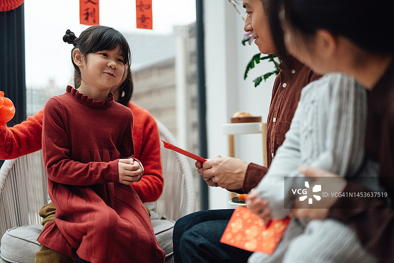 欢快的年轻亚洲家庭在家里庆祝中国新年图片素材