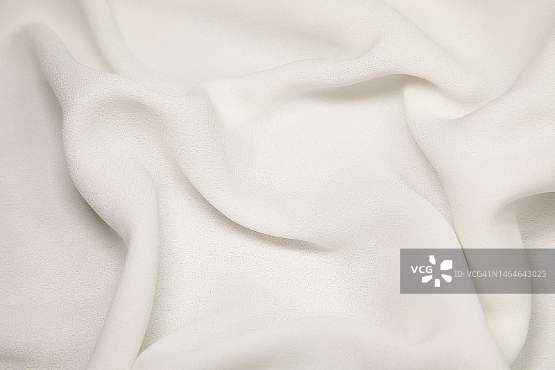 白色织物背景。白布波浪背景纹理。白色织物织物纺织材料。图片素材
