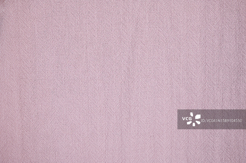 粉红色的织物纹理背景。图片素材