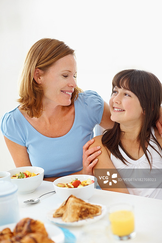 中年妇女和她的女儿在早餐桌上图片素材