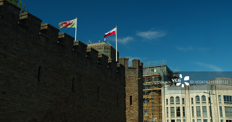 卡迪夫城堡桅杆上的波兰和威尔士国旗图片素材